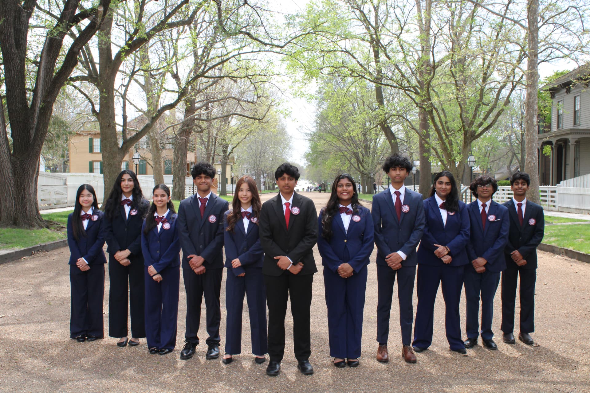Illinois HOSA state officers standing together on a tree-lined path